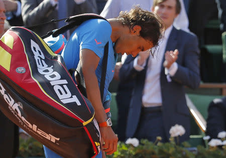 Rafael Nadal of Spain leaves the court after being defeated by Novak Djokovic Wednesday in Paris. (REUTERS/Vincent Kessler)