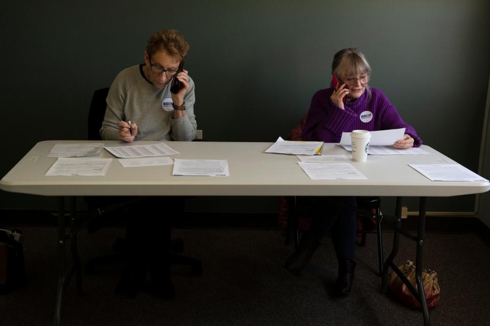 Volunteers Sherry Pittinger, left, and Ellen Martell call potential voters from the Joe Biden campaign office in Greenville, S.C., on Feb. 15.