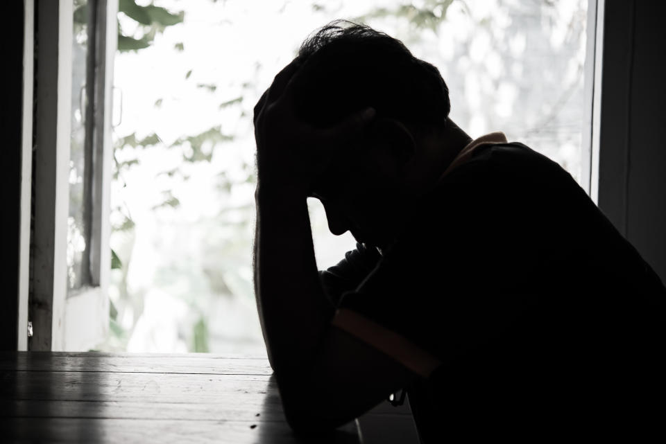 Silhouette Depressed Man Sitting At Table