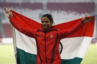 Athletics - 2018 Asian Games - Women's 100m Final - GBK Main Stadium – Jakarta, Indonesia – August 26, 2018 – Silver medallist Dutee Chand of India poses with her national flag during the medal ceremony. REUTERS/Darren Whiteside