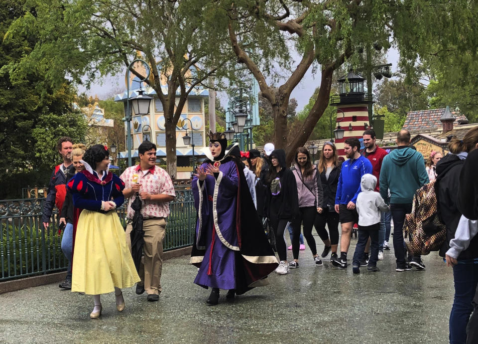 A visitor around at Disneyland in Anaheim, Calif. on Friday, March 13, 2020. Disneyland is closing its doors for the rest of the month, shuttering one of California's best-known attractions as the state hurries to stop the spread of the coronavirus. (AP Photo/Amy Taxin)