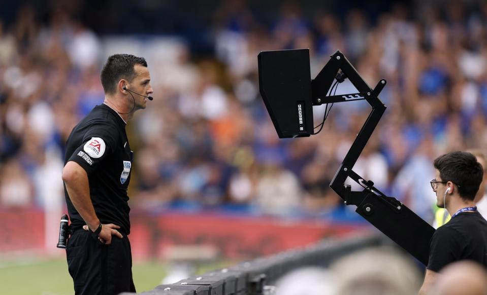 Referee Andrew Madley consults the pitch side monitor before disallowing Cornet’s equaliser (Steven Paston/PA) (PA Wire)