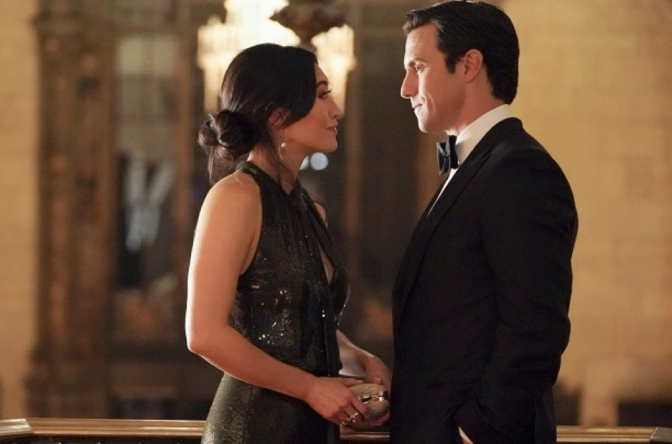 couple in black tie attire standing face to face