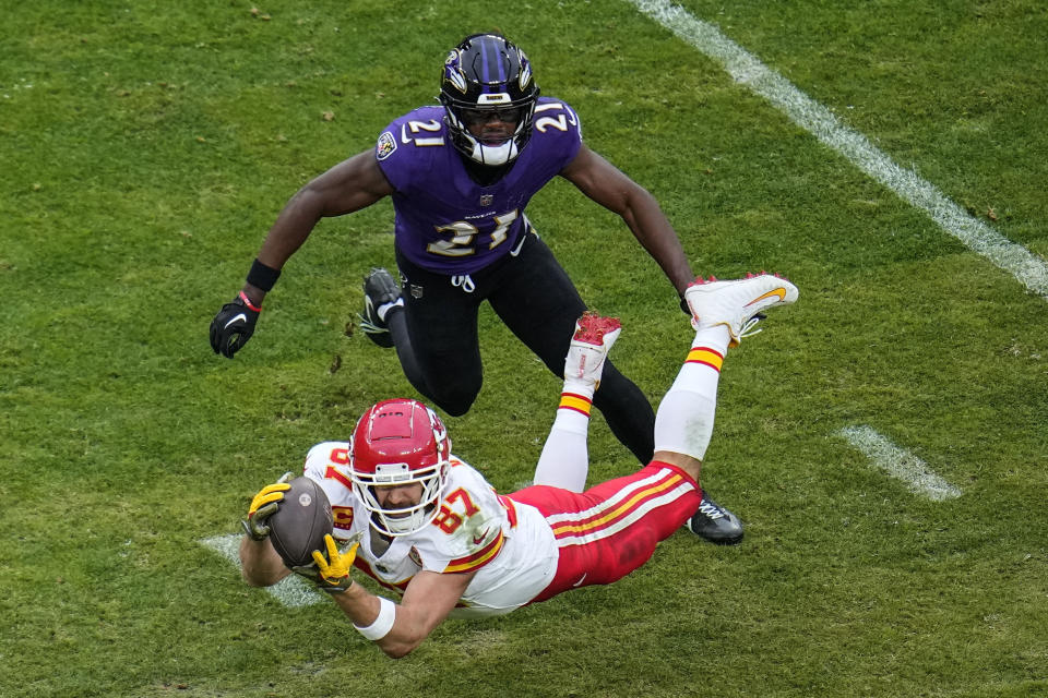 Kansas City Chiefs tight end Travis Kelce (87) makes the catch against Baltimore Ravens cornerback Brandon Stephens (21) during the first half of an AFC Championship NFL football game, Sunday, Jan. 28, 2024, in Baltimore. (AP Photo/Julio Cortez)
