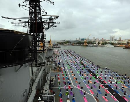 Members of Indian Navy perform yoga on the flight deck of INS Viraat, an Indian Navy's decommissioned aircraft carrier during International Yoga Day in Mumbai, June 21, 2017. REUTERS/Danish Siddiqui