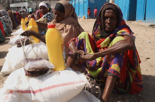 Women from southern Somalia wait for food-aid to be distributed by a local humanitarian organisation, at the Maalin Internally Displaced Persons (IDP) camp in the Howlwadag district in Mogadishu, on August 31. Famine-hit areas of southern Somalia will likely spread in coming days, with the situation continuing to worsen despite massive international aid efforts, the United Nations has warned