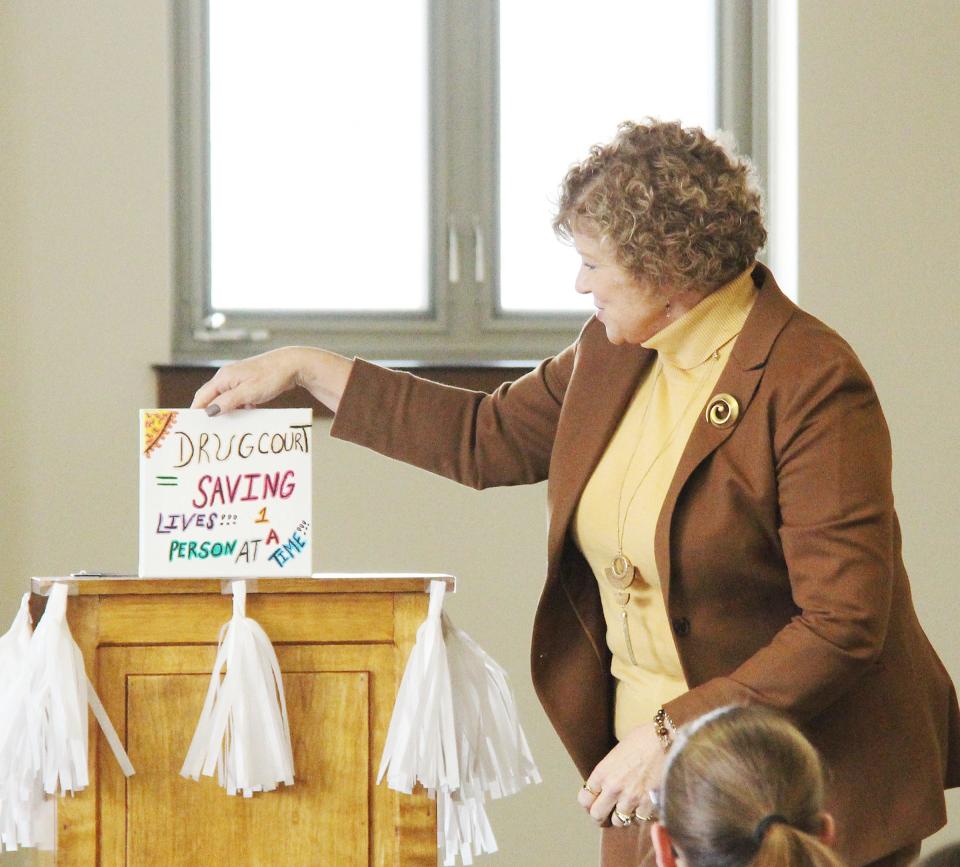 Judge Jennifer Bauknecht reads a quote from Charles Phinney regarding drug court during Phinney's graduation ceremony on March 31.