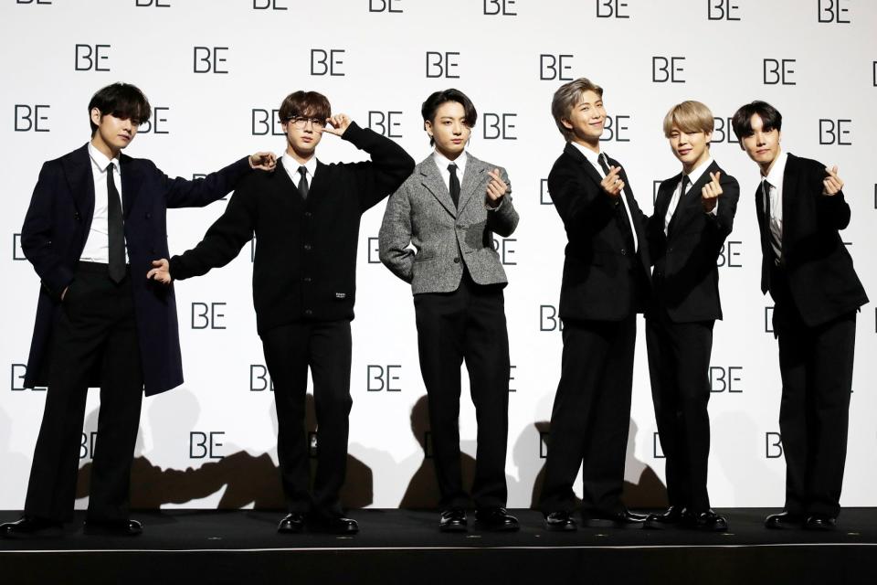 <p>BTS smiles for the cameras during a press conference ahead of the release of their album <em>Be</em> on Friday in Seoul, South Korea.</p>