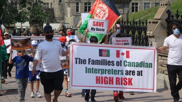 A rally on Parliament Hill calling on the government to speed up and expand its resettlement program for Afghans who assisted Canada in its mission in Afghanistan. (Ashley Burke/CBC - image credit)