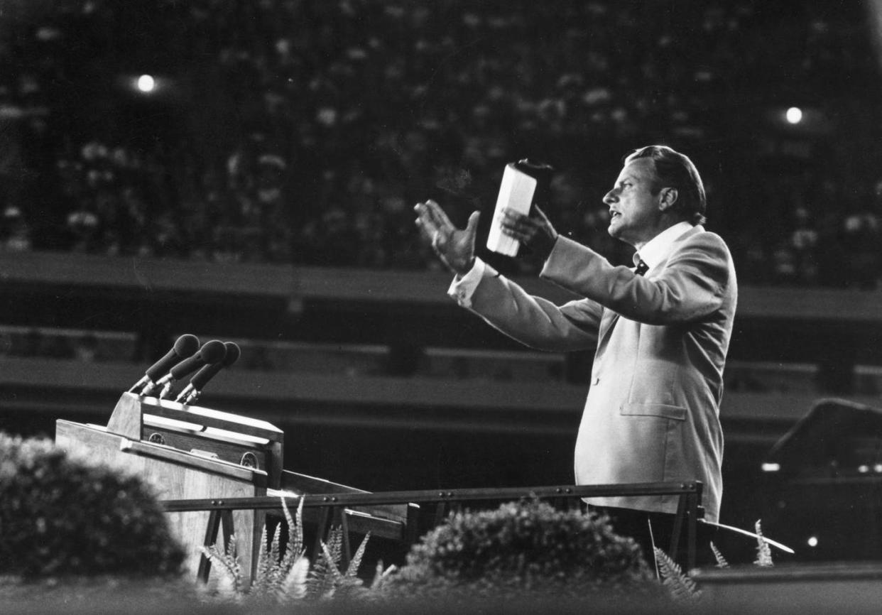 <span class="caption">Evangelist <span class="caas-xray-inline-tooltip"><span class="caas-xray-inline caas-xray-entity caas-xray-pill rapid-nonanchor-lt" data-entity-id="Billy_Graham" data-ylk="cid:Billy_Graham;pos:1;elmt:wiki;sec:pill-inline-entity;elm:pill-inline-text;itc:1;cat:ReligiousFigure;" tabindex="0" aria-haspopup="dialog"><a href="https://search.yahoo.com/search?p=Billy%20Graham" data-i13n="cid:Billy_Graham;pos:1;elmt:wiki;sec:pill-inline-entity;elm:pill-inline-text;itc:1;cat:ReligiousFigure;" tabindex="-1" data-ylk="slk:Billy Graham;cid:Billy_Graham;pos:1;elmt:wiki;sec:pill-inline-entity;elm:pill-inline-text;itc:1;cat:ReligiousFigure;" class="link ">Billy Graham</a></span></span> came to have an enormous influence on American politics and culture.</span> <span class="attribution"><a class="link " href="https://www.gettyimages.com/detail/news-photo/evangelist-billy-graham-addressing-a-meeting-news-photo/3317456?adppopup=true" rel="nofollow noopener" target="_blank" data-ylk="slk:Keystone/ Collections Hulton Archive/Getty Images;elm:context_link;itc:0;sec:content-canvas">Keystone/ Collections Hulton Archive/Getty Images</a></span>