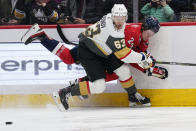 Vegas Golden Knights right wing Evgenii Dadonov (63) takes the puck away from Washington Capitals center Connor McMichael (24) during the second period of an NHL hockey game, Monday, Jan. 24, 2022, in Washington. (AP Photo/Evan Vucci)