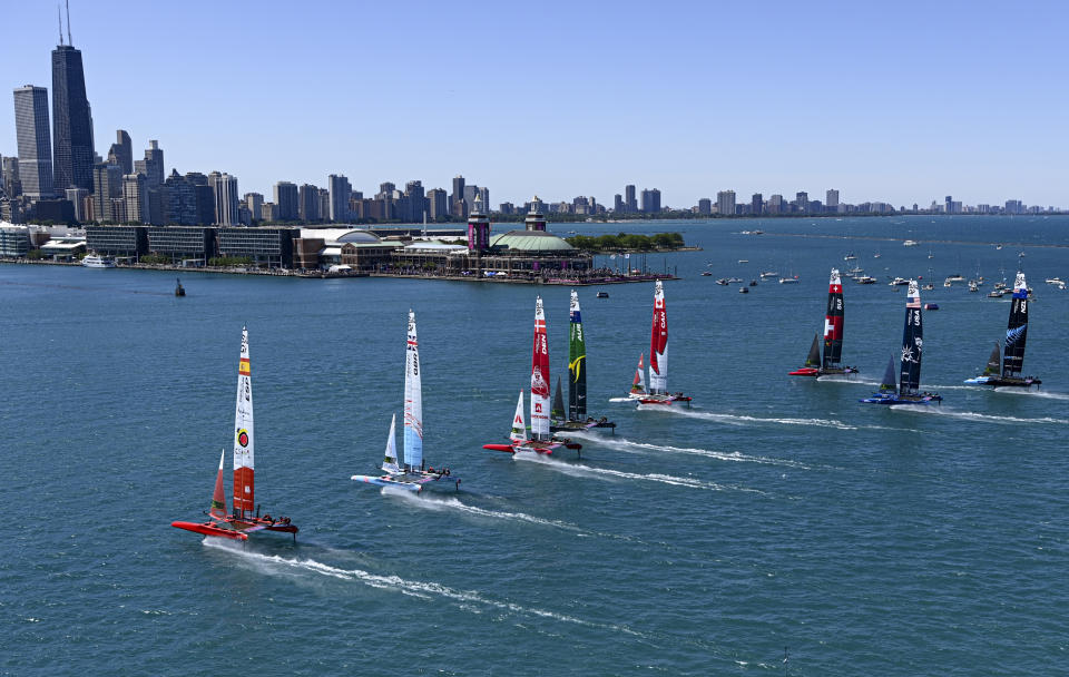 In this photo provided by SailGP, the SailGP F50 catamaran fleet sail toward the Chicago skyline during the United States Sail Grand Prix on Lake Michigan in Chicago,, Saturday, June 18, 2022. (Jon Buckle/SailGP via AP)