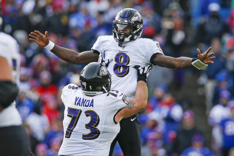 Baltimore Ravens quarterback Lamar Jackson (8) celebrates a 61-yard touchdown play with Marshal Yanda during the second half of an NFL football game against the Buffalo Bills in Orchard Park, N.Y., Sunday, Dec. 8, 2019. (AP Photo/John Munson)