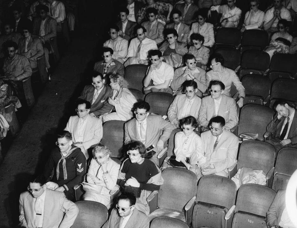 A cinema audience wearing 3D glasses in 1940