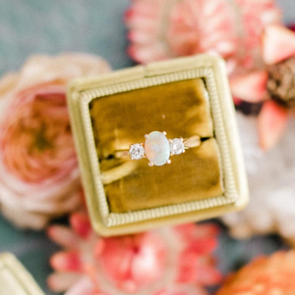 Engagement Ring Trends 2021: opal and diamond three-stone engagement ring in gold velvet ring box