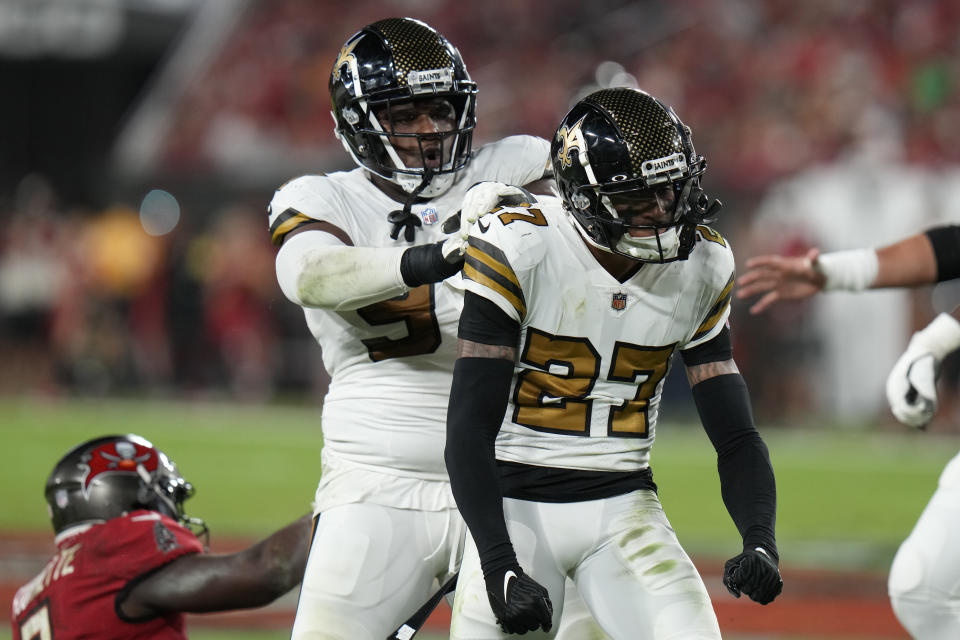 New Orleans Saints cornerback Alontae Taylor (27) celebrates a defensive stop with defensive end Malcolm Roach in the first half of an NFL football game against the Tampa Bay Buccaneers in Tampa, Fla., Monday, Dec. 5, 2022. (AP Photo/Chris O'Meara)