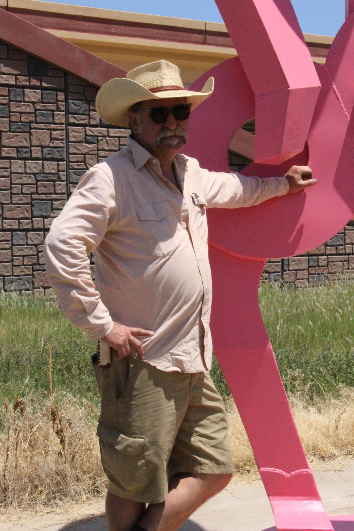 Artist B.C. Gilbert, who earned his master of fines arts degree from Texas Tech, completed two "Friendly Cowboy" sculptures now greeting drivers on area roadways.