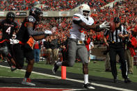 LUBBOCK, TX - NOVEMBER 12: Isaiah Anderson #82 of the Oklahoma State Cowboys makes a touchdown pass against D.J. Johnson #12 of the Texas Tech Red Raiders at Jones AT&T Stadium on November 12, 2011 in Lubbock, Texas. (Photo by Ronald Martinez/Getty Images)