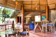 <p>The first floor features a central living/dining area constructed of beautiful tropical wood floors. <br> (Airbnb) </p>
