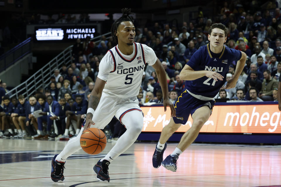 UConn guard Stephon Castle (5) drives past Northern Arizona guard Liam Lloyd during the first half of an NCAA college basketball game, Monday, Nov. 6, 2023, in Storrs, Conn. (AP Photo/Mary Schwalm)