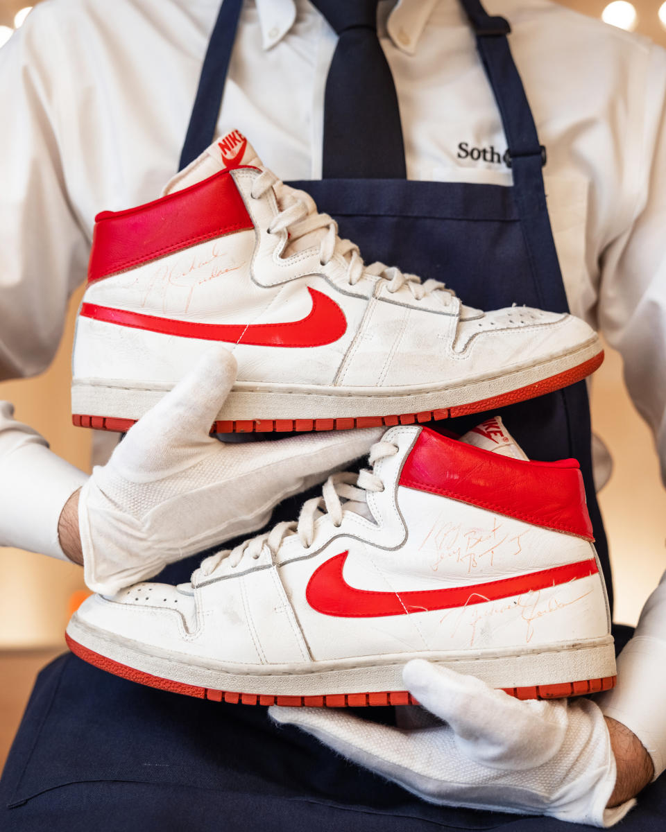 A Sotheby's employee holds the pair of Michael Jordan's Nike Air Ships from 1984 that sold for $1.472 million at auction. (Julian Cassady Photography / via Sotheby's)