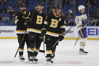 Boston Bruins center Charlie Coyle, center, skates alongside right wing Craig Smith, left, and center Brad Marchand, right, after scoring during the second period of an NHL hockey game against the Buffalo Sabres, Friday, Oct. 22, 2021, in Buffalo, N.Y. (AP Photo/Joshua Bessex)