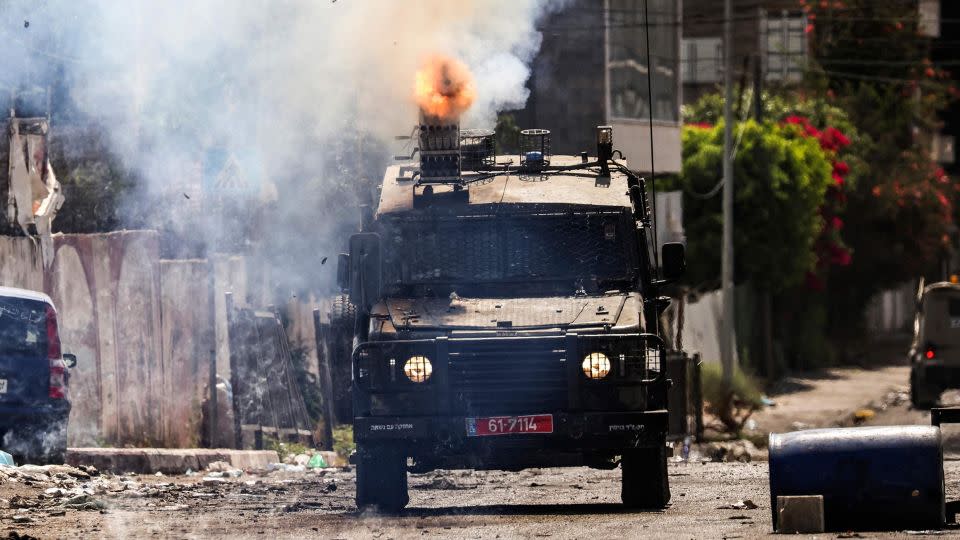An Israeli armored vehicle fires tear gas during the military operation in Jenin in the occupied West Bank on July 4. - Robaldo Schemidt/AFP/Getty Images