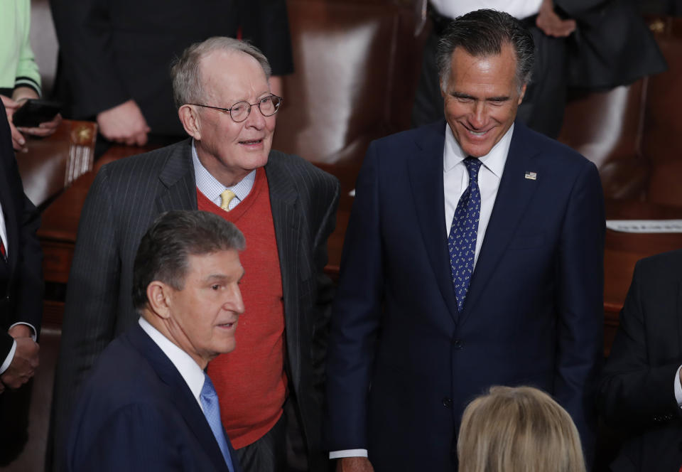 In this Tuesday, Feb. 5, 2020 photo, from left, Sen. Joe Manchin, D-W.Va., Sen. Lamar Alexander, R-Tenn., and Sen. Mitt Romney, R-Utah, arrive for the State of the Union speech by President Donald Trump, at the Capitol in Washington. The Republican-controlled Senate is expected to acquit Trump today in his impeachment trial on impeachment charges of abuse of power and obstruction of Congress. (AP Photo/J. Scott Applewhite)