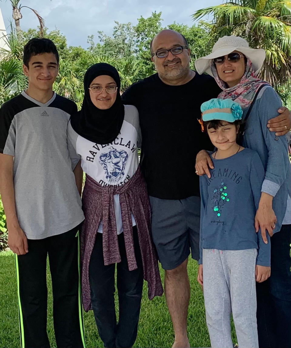 In this undated photo provided by David Oates, Dr. Hasan Gokal, third right, is pictured with his wife, two daughters and son. A grand jury on Wednesday, June 30, 2021, declined to indict Gokal, the former Houston-area Harris County Public Health doctor who was accused of stealing nine doses of coronavirus vaccine from a damaged vial and administering them to family and friends. In an interview with The Associated Press, Gokal said his decision “was the right thing to do and it meant saving more lives.” (Courtesy of David Oates via AP)