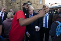 Britain's Prime Minister Boris Johnson poses for a selfie with a member of the public during a visit to Doncaster Market, in Doncaster, Northern England, Friday Sept. 13, 2019. Johnson will meet with European Commission president Jean-Claude Juncker for Brexit talks Monday in Luxembourg. The Brexit negotiations have produced few signs of progress as the Oct. 31 deadline for Britain’s departure from the European Union bloc nears. ( AP Photo/Jon Super)