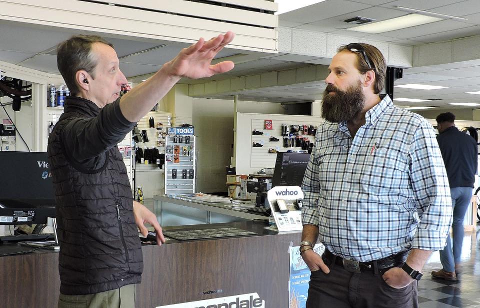 Jim Fungaroli, owner of Fat Jimmy's Cycle and Fitness in Johnstown, left, talks with Nathan Reigner, Pennsylvania's director of outdoor recreation, April 26, about the variety of bicycling options and trails in southwestern Pennsylvania.