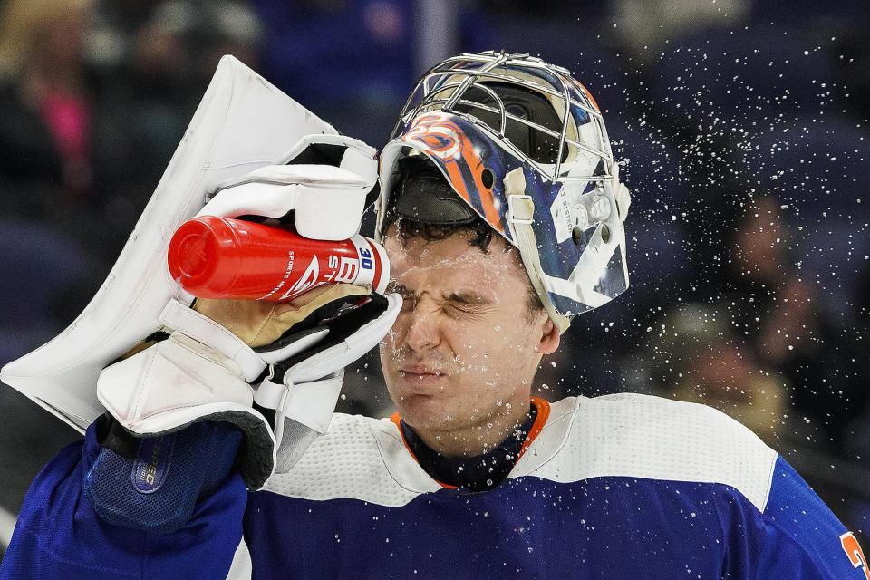 New York Islanders goaltender Ilya Sorokin (30) sprays water on his face during the third period of an NHL hockey game against the Ottawa Senators Tuesday, Feb. 14, 2023, in Elmont, N.Y. (AP Photo/Eduardo Munoz Alvarez)