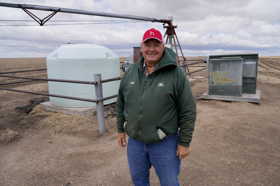 Steve Hanson poses for a photo in front of one of his water pumping stations Saturday, April 30, 2022, in Elsie, Neb. He raises beef cattle and grows corn, all of his irrigation water coming from the Ogallala Aquifer. (AP Photo/Brittany Peterson)