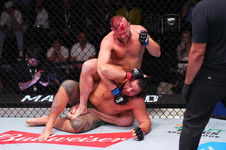 LAS VEGAS, NEVADA - MARCH 16: Marcin Tybura of Poland punches Tai Tuivasa of Australia in their heavyweight fight during the UFC Fight Night event at UFC APEX on March 16, 2024 in Las Vegas, Nevada. (Photo by Jeff Bottari/Zuffa LLC via Getty Images)