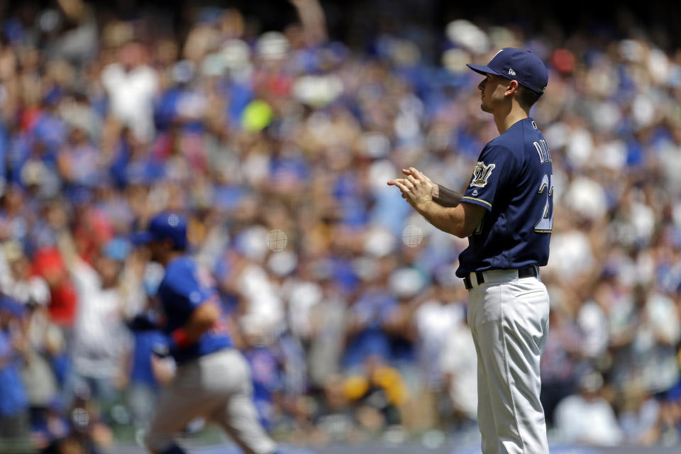 Milwaukee Brewers' Zach Davies, right, reacts after giving up grand slam to Chicago Cubs' Kyle Schwarber during the second inning of baseball game Sunday, July 28, 2019, in Milwaukee. (AP Photo/Aaron Gash)