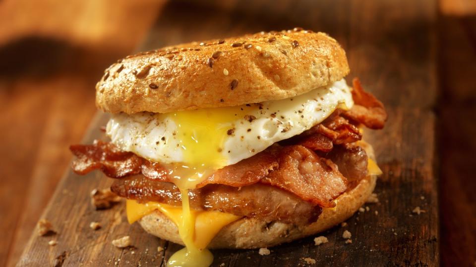bagel, bacon, sausage and egg breakfast sandwich