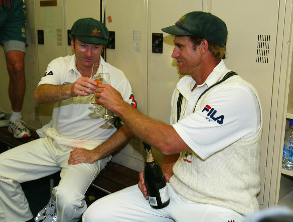 Matthew Hayden and captain Steve Waugh cheers a champagne glass.