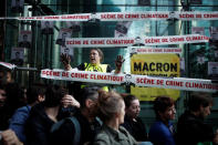 Environmental activists block the entrance of the French bank Societe Generale headquarters during a "civil disobedience action" to urge world leaders to act against climate change, in La Defense near Paris, France, April 19, 2019. REUTERS/Benoit Tessier