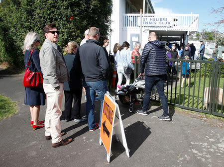 Voters wait outside a polling station at the St Heliers Tennis Club during the general election in Auckland, New Zealand, September 23, 2017. REUTERS/Nigel Marple