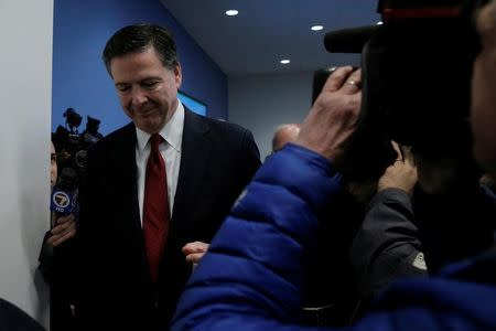 FBI Director James Comey walks past reporters and news cameras without comment after a ceremony to open the new FBI Boston Field Office in Chelsea, Massachusetts, U.S., March 7, 2017. REUTERS/Brian Snyder -