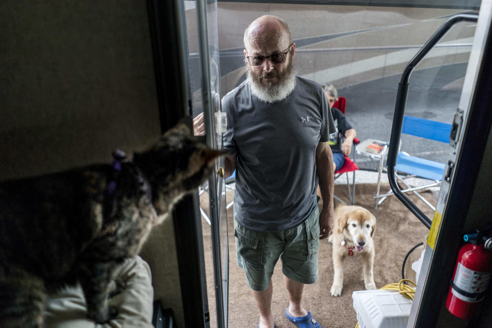 Marge and Steve Durham, with their dog Seti and Saba the cat, from Myrtle Beach South Carolina park their RVs and settle into the Family Campground section of the Atlanta Motor Speedway which has been made available for evacuees fleeing Hurricane Florence's path in Hampton Georgia on Thursday September 13, 2018.