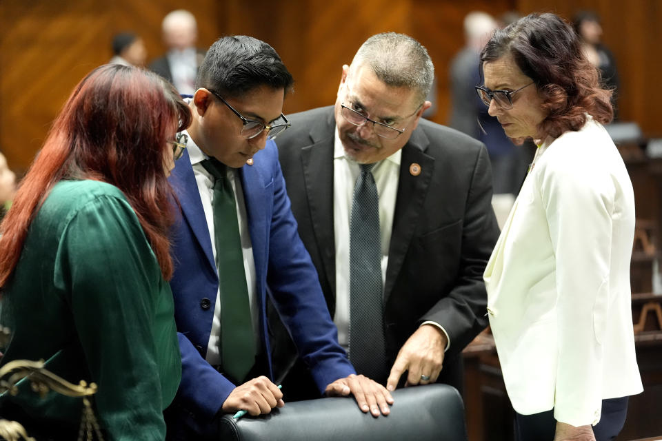 From left; Democratic Arizona State Representatives Melody Hernandez, Oscar De Los Santos, Lupe Contreras and Nancy Gutierrez speak together on the House floor, Wednesday, April 17, 2024, at the Capitol in Phoenix. House Republicans have again blocked an effort for the chamber to take up legislation that would repeal Arizona’s near-total ban on abortions. (AP Photo/Matt York)