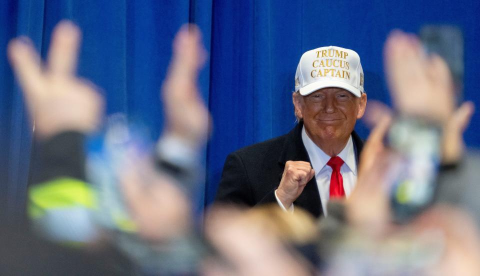 Former President Donald Trump pumps his fist during a campaign event ahead of the Iowa Caucus on Sunday, Jan. 14, 2024, at Simpson College in Indianola.