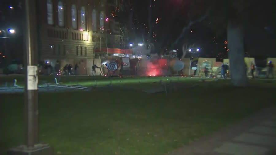 A firework was ignited and thrown into an pro-Palestinian encampment by a pro-Israel protestor at the UCLA campus on April 30, 2024. (KTLA)