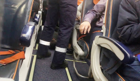 Police officers detain a man after failed attempt to hijack plane, Khanty-Mansiysk, Russia January 22, 2019 in this image obtained from a social media on January 22, 2019. MAXIM TVERITNEV/via REUTERS