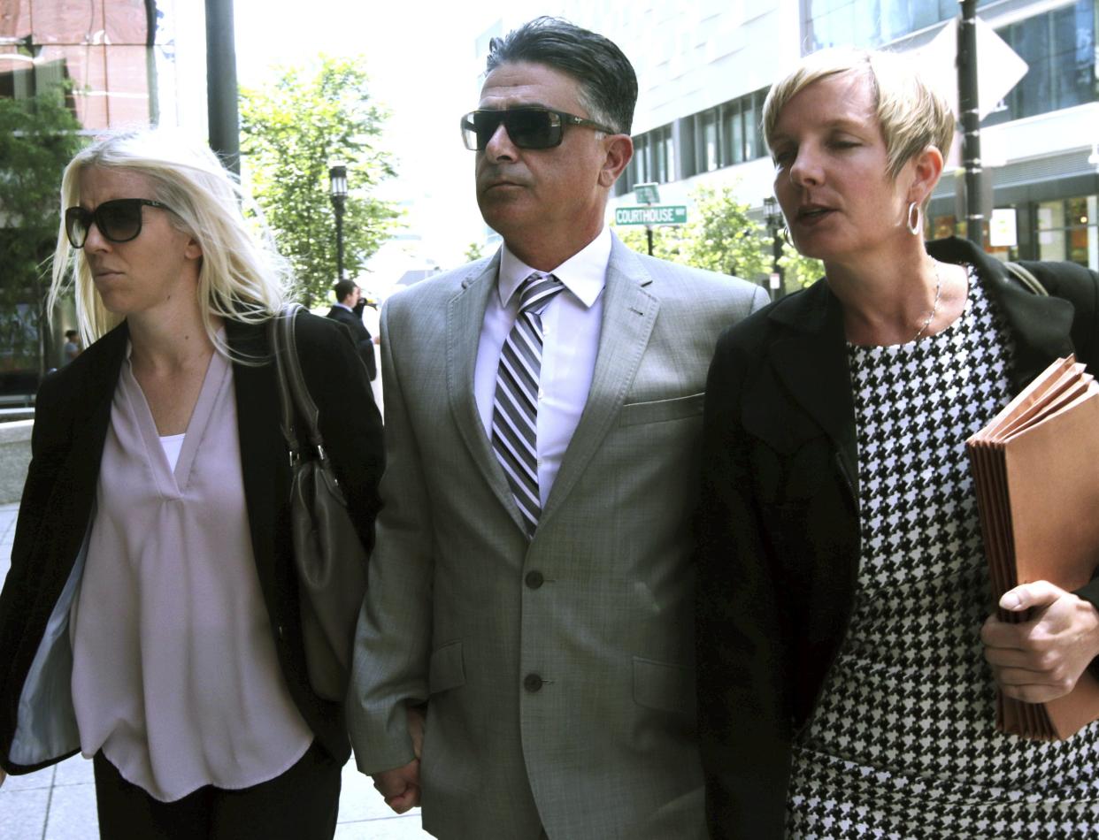 Former USC women's soccer coach Ali Khosroshahin (center) arrives at federal court in Boston on June 27, 2019, to face charges in a nationwide college admissions bribery scandal.