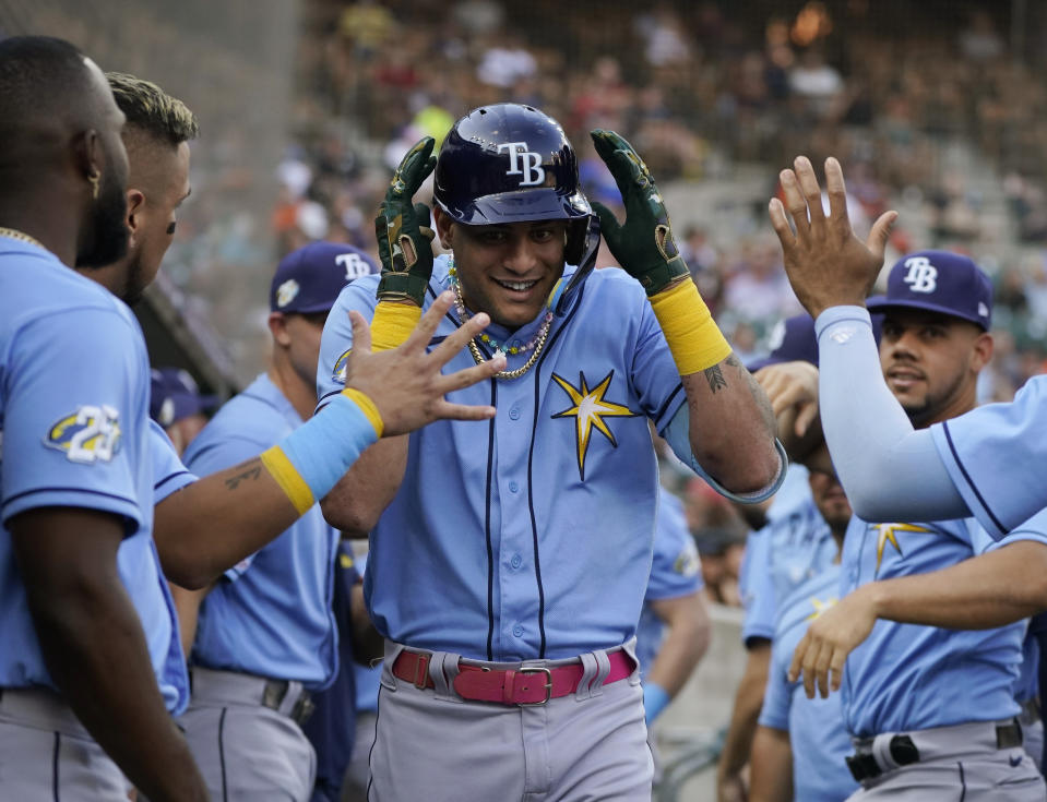 Tampa Bay Rays' Jose Siri is greeted in the dugout after his two-run home run during the second inning of a baseball game against the Detroit Tigers, Friday, Aug. 4, 2023, in Detroit. (AP Photo/Carlos Osorio)