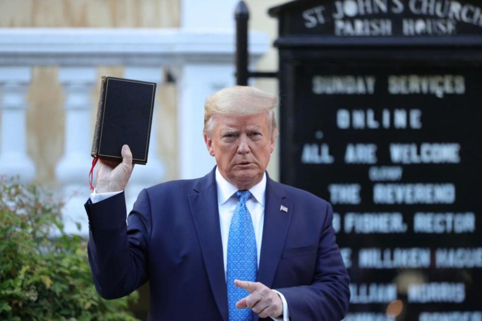 Donald Trump holds up a Bible during a photo opportunity in front of St John’s Episcopal church on Monday.