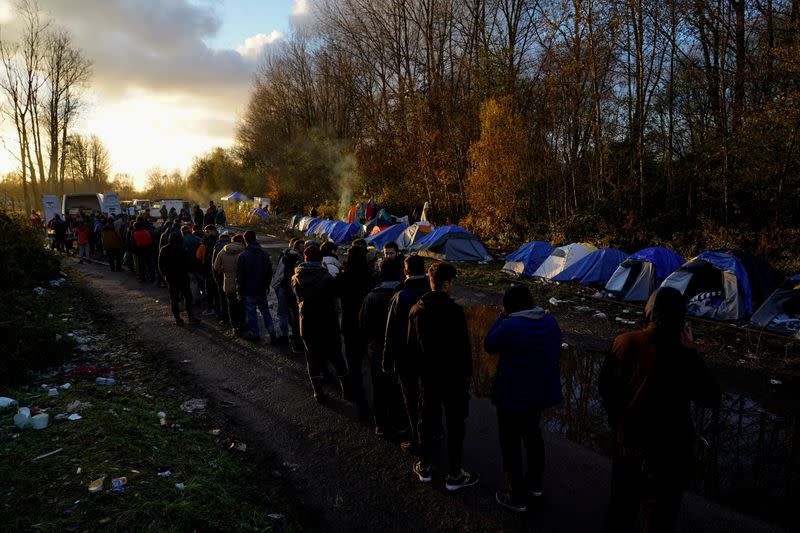 FILE PHOTO: Kurdish migrants queue for food at a makeshift camp in Loon-Plage near Dunkirk, France,