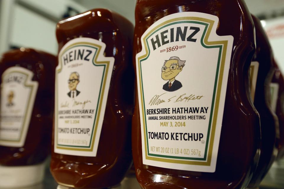 Heinz commemorative Ketchup bottles bear the cartoon likeness of investor Warren Buffett, right, and of his second in command Charlie Munger, left, at a Heinz display in Omaha, Neb., Friday, May 2, 2014, one day before the Berkshire Hathaway annual shareholders meeting which takes place on Saturday. (AP Photo/Nati Harnik)